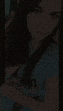 a woman wearing a blue shirt with a leopard print on it takes a selfie