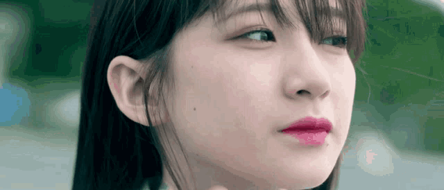 a close up of a woman 's face with red lips
