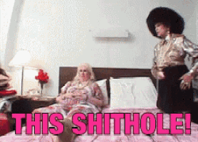 a woman sitting on a bed with the words " this shithole " written in pink