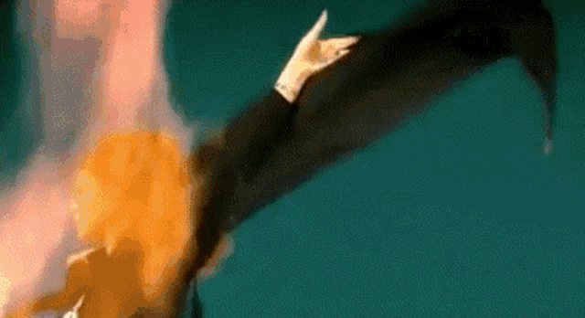 a cartoon character is flying through the air with a sword .