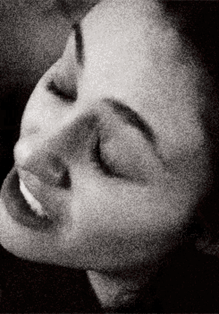 a close up of a woman with her eyes closed
