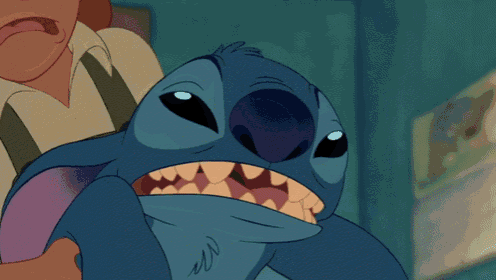 a close up of a stitch cartoon character with its mouth wide open