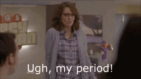 a woman in a plaid shirt and glasses is standing in front of a sign that says `` ugh , my period ! ''