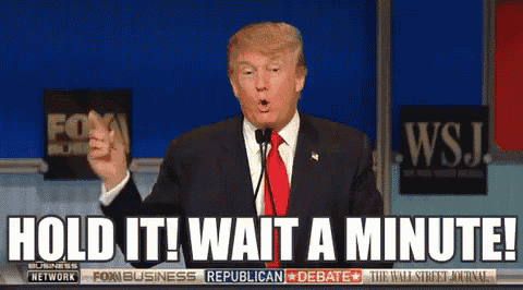 donald trump says hold it wait a minute in front of a fox business republican debate sign