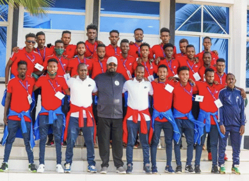 a group of men posing for a picture with one wearing a name tag that says ' ethiopia '