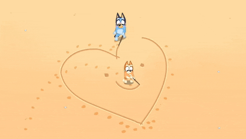 two cartoon dogs are drawing a heart in the sand
