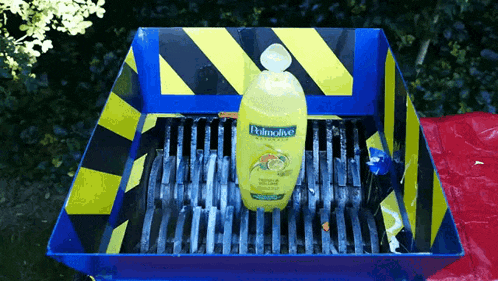 a bottle of palmolive shampoo sits in a blue container