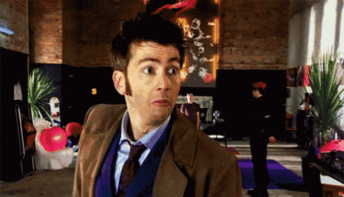 a man in a suit and tie stands in a room