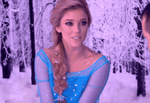 a woman in a frozen costume with a tattoo on her arm that says " i love you "