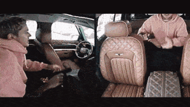 a man in a pink hoodie is standing next to a woman in a car