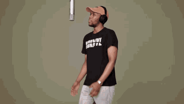 a man singing into a microphone wearing a t-shirt that says when u thirsty