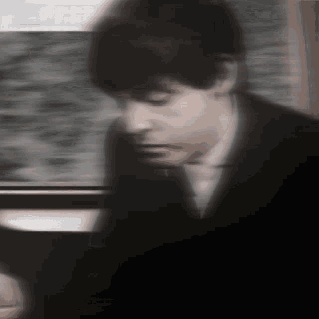 a blurry image of a man in a suit and tie
