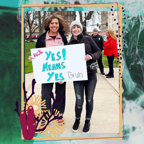 two women holding a sign that says yes means yes