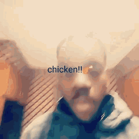 a blurry picture of a man with the word chicken written on his face