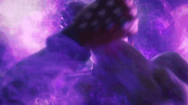 a close up of a person holding an american flag in a purple foggy background .