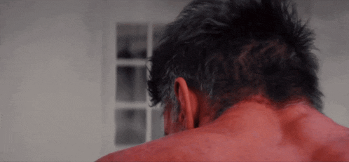 a close up of a man 's head and neck with red hair