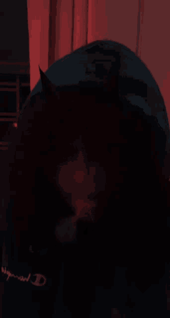 a person is smoking a cigarette in a dark room