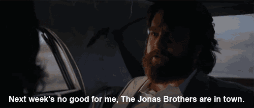 a man with a beard is sitting in a car and says next week 's no good for me