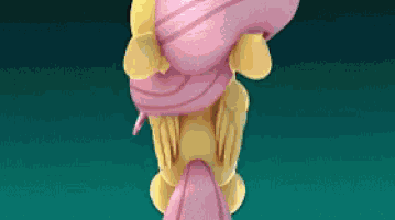 a close up of a pink and yellow object on a green background .