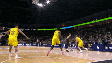 a basketball player wearing a yellow jersey with the number 32 on it