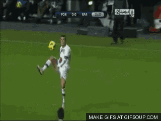 a soccer player kicks the ball during a game between portugal and spain