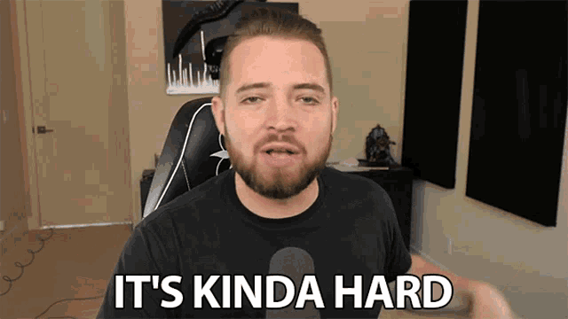 a man with a beard says it 's kinda hard in front of a microphone