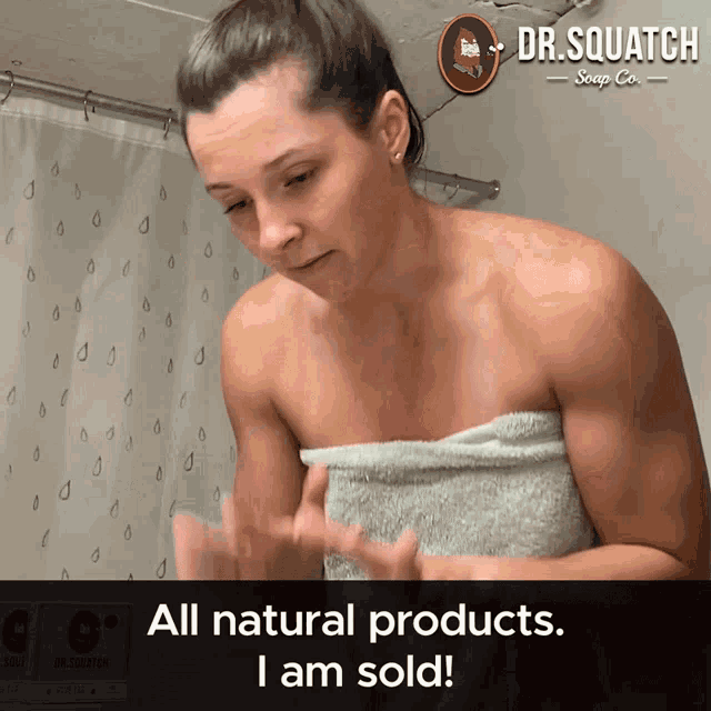 a woman is wrapped in a towel with the words all natural products i am sold