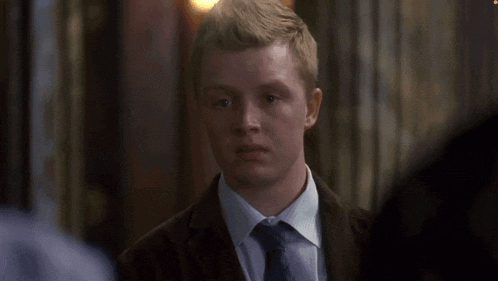 a man in a suit and tie looks at something