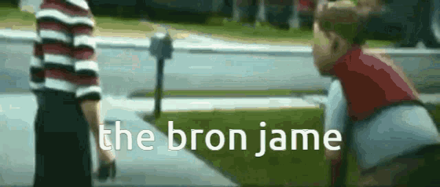 a blurred image of two children standing on a sidewalk with the words " the bron jame " written on the bottom