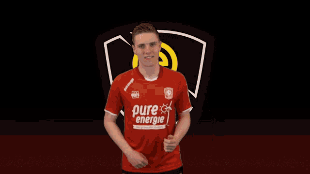 a young man wearing a red shirt that says pure energie on it