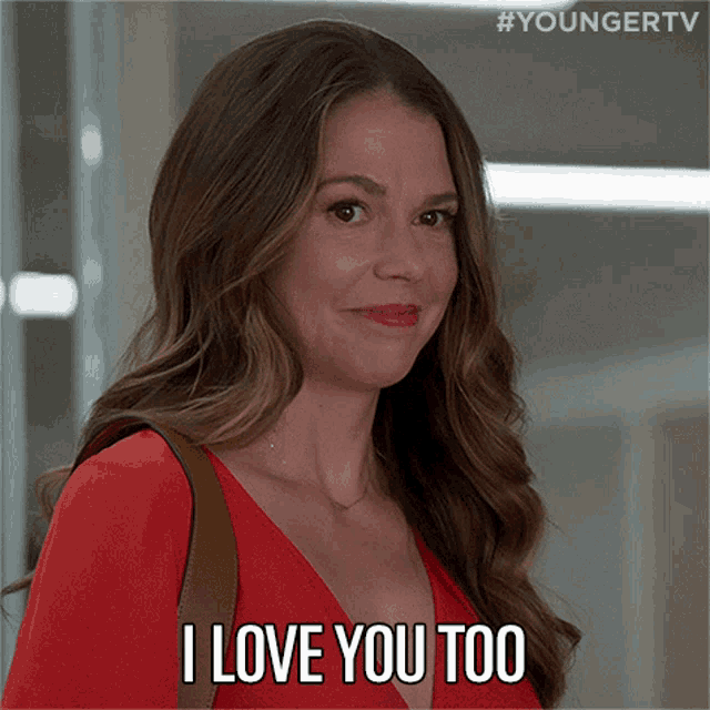 a woman in a red dress is saying " i love you too "