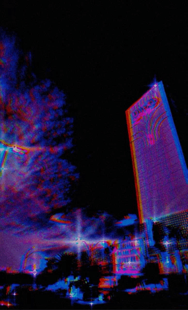 a building with the word palace on it is lit up at night