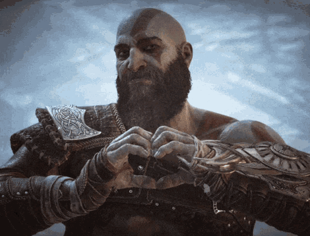 a bald man with a beard is wearing armor and holding something in his hands