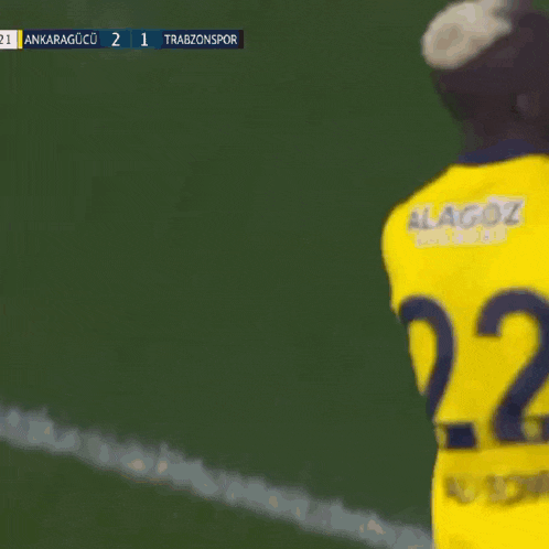 a soccer player wearing a yellow jersey with the number 27 on it