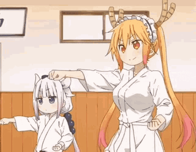 a couple of anime girls are standing next to each other in a room . one of the girls is wearing a karate uniform .