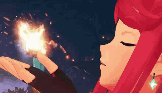 a girl with red hair is blowing a fireball in her hand .