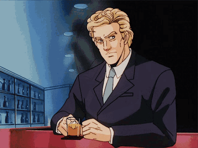 a man in a suit and tie is sitting at a bar holding a drink