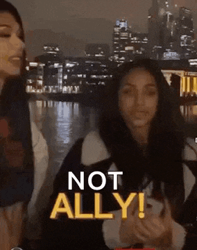 a couple of women standing next to each other with the words `` not ally '' .