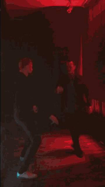 a blurry photo of a man walking in a dark room
