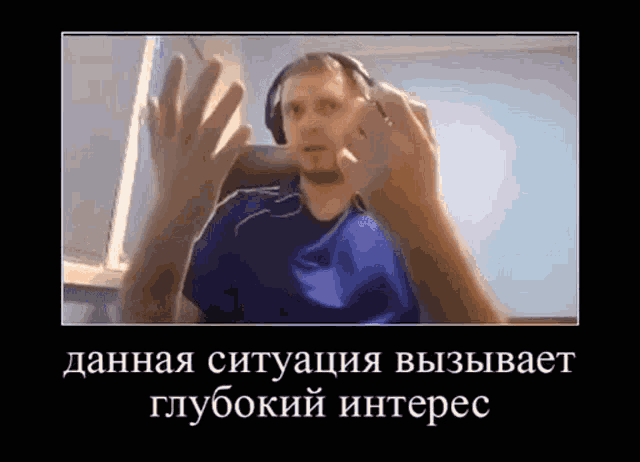 a man wearing headphones and a blue shirt is making a face .