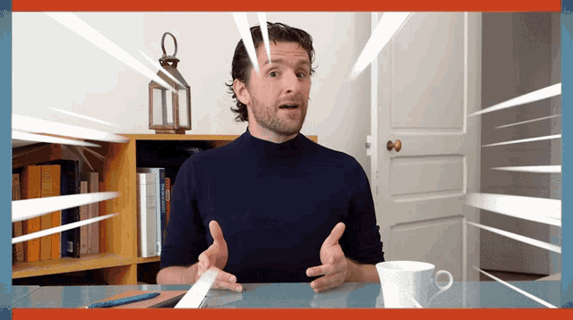 a man is sitting at a desk with a cup of coffee and a dictionary on the shelf