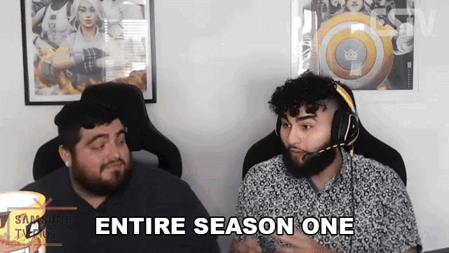 two men are sitting in chairs and one of them is wearing headphones and says entire season one