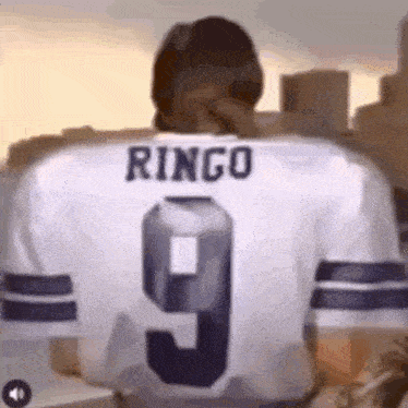 a man wearing a white jersey with the name ringo on the back .