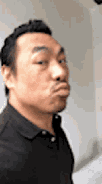 a close up of a man making a funny face .