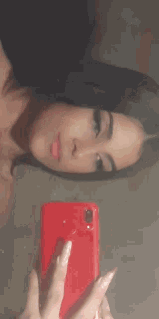 a woman is taking a picture of herself in the mirror with her phone .