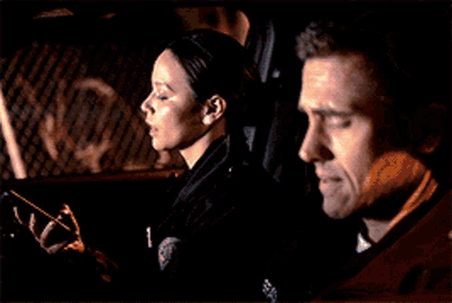 a man and a woman are sitting in a car and the woman is saying not no one
