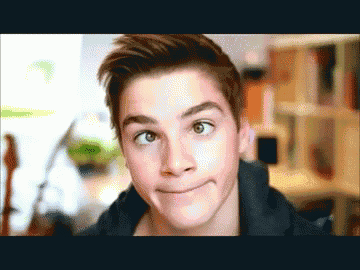 a young man making a funny face with his eyes wide open