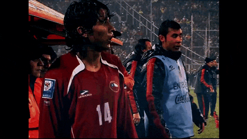 a soccer player with the number 14 on his shirt