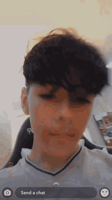 a boy is taking a picture of himself with the words send a chat on the bottom