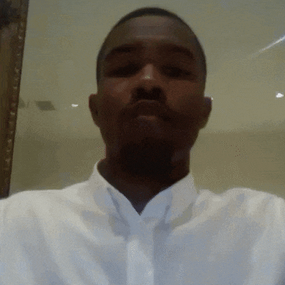 a man in a white shirt and tie is taking a selfie .